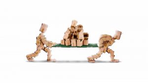 Cardboard Box Men Carrying A Pile Of Cardboard Boxes On A Green Stretcher