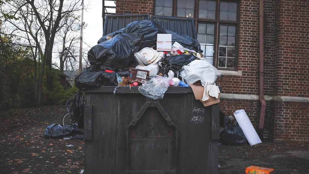 Large Waste Rubbish Bin Overflowing With Waste After De-Cluttering Home