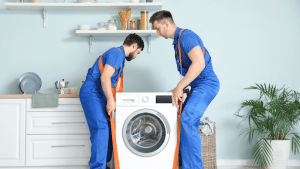 Two guys removing a washing machine