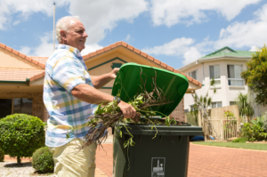 Man putting green waste into green bin